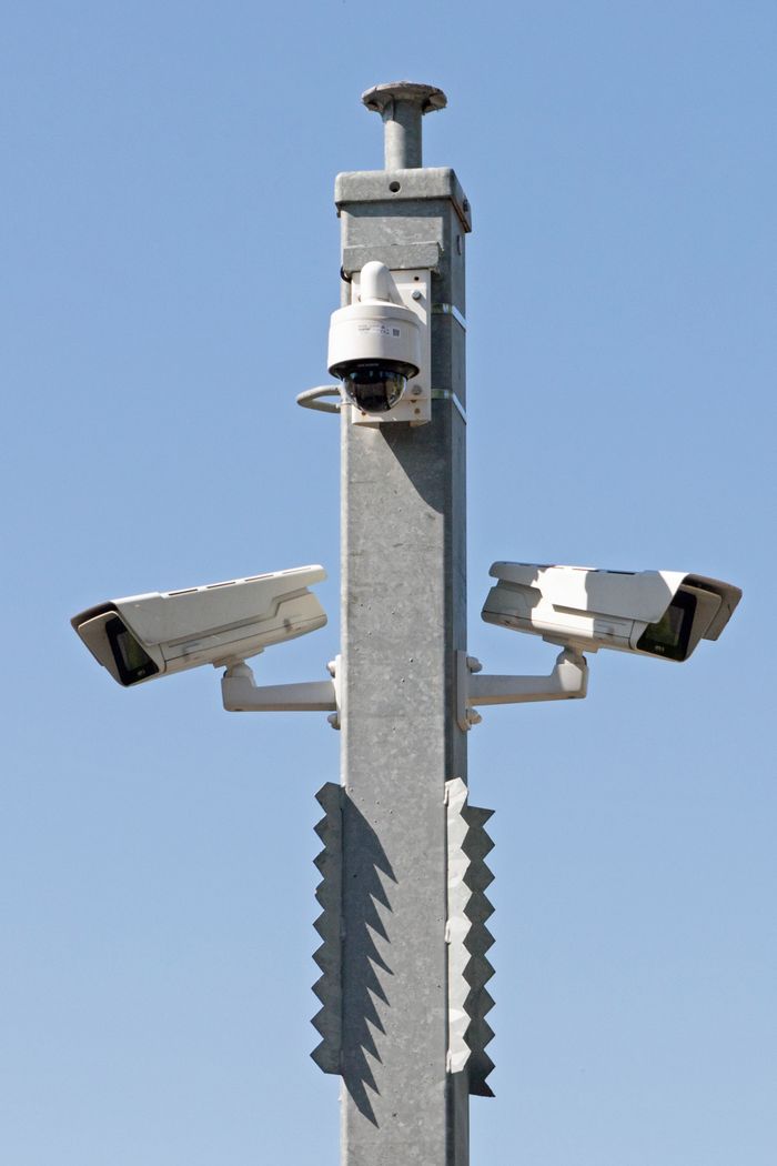 Crafting Captivating Headlines: Your awesome post title goes here Outdoor surveillance system with multiple cameras mounted on a metal pole against blue sky.