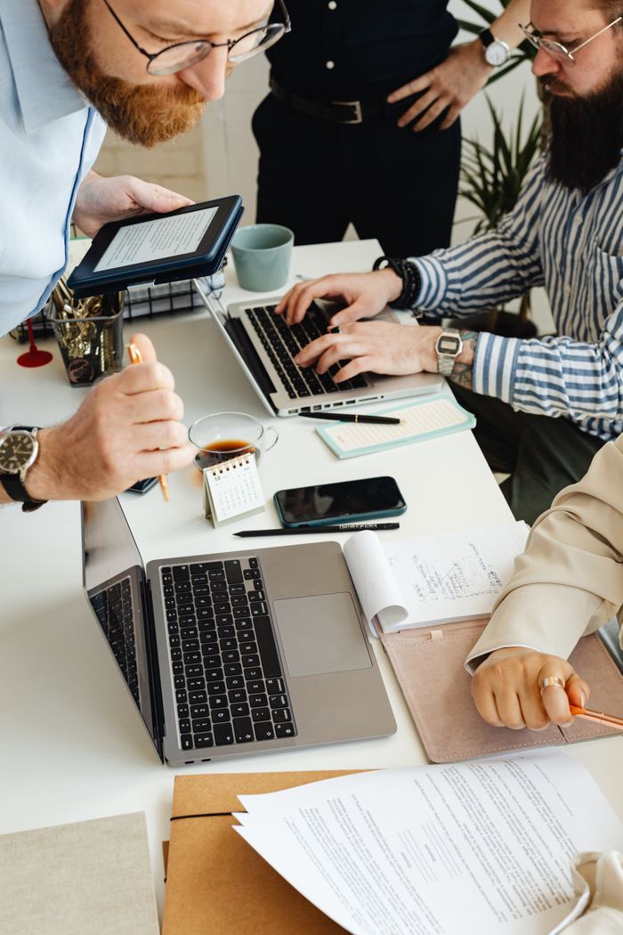 Mastering the First Impression: Your intriguing post title goes here Teamwork in action with technology, papers, and collaboration at a dynamic office desk.